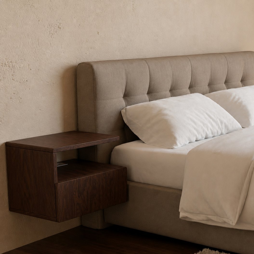 The MOA MADE floating nightstand in walnut, mounted on the wall beside a bed.